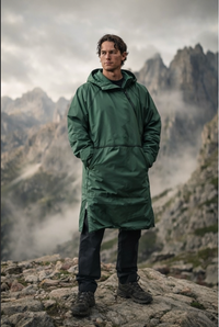 Man wearing V1 RoamCoat packable waterproof jacket walking outdoors